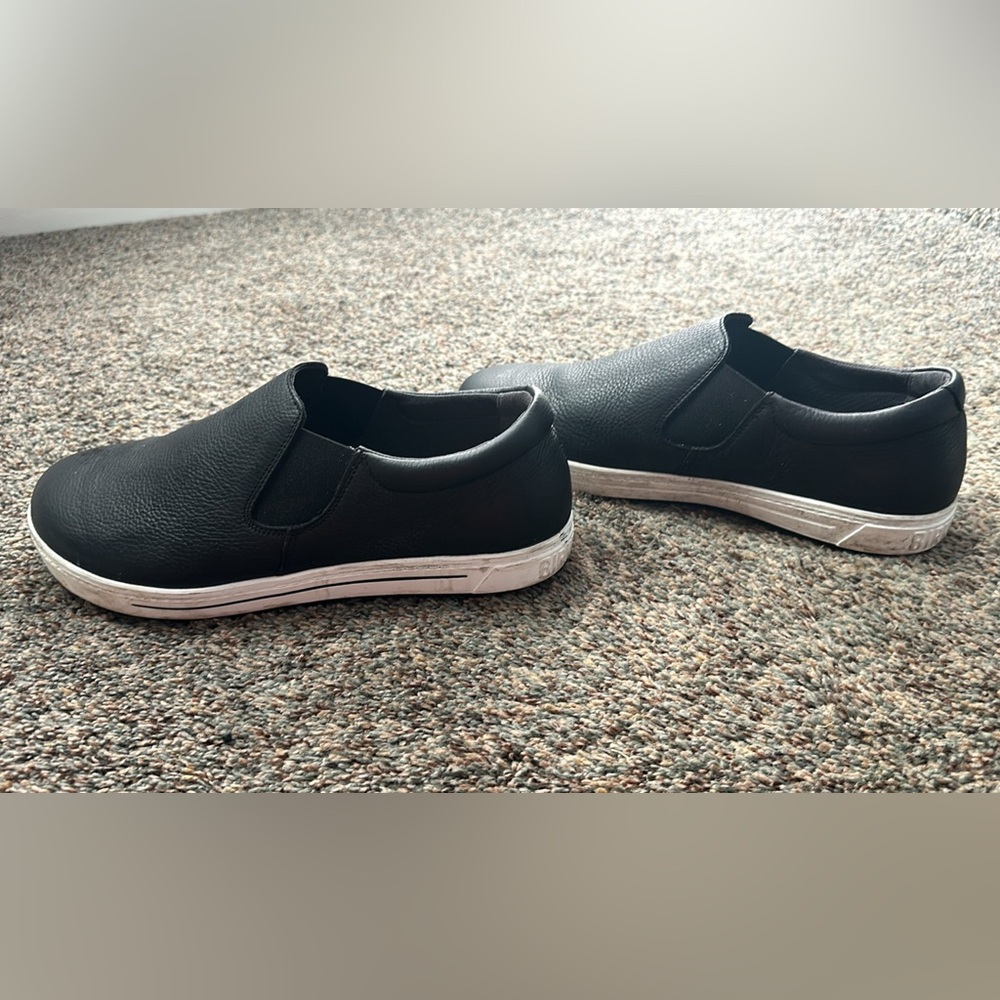 Black leather birkenstock shoes.
